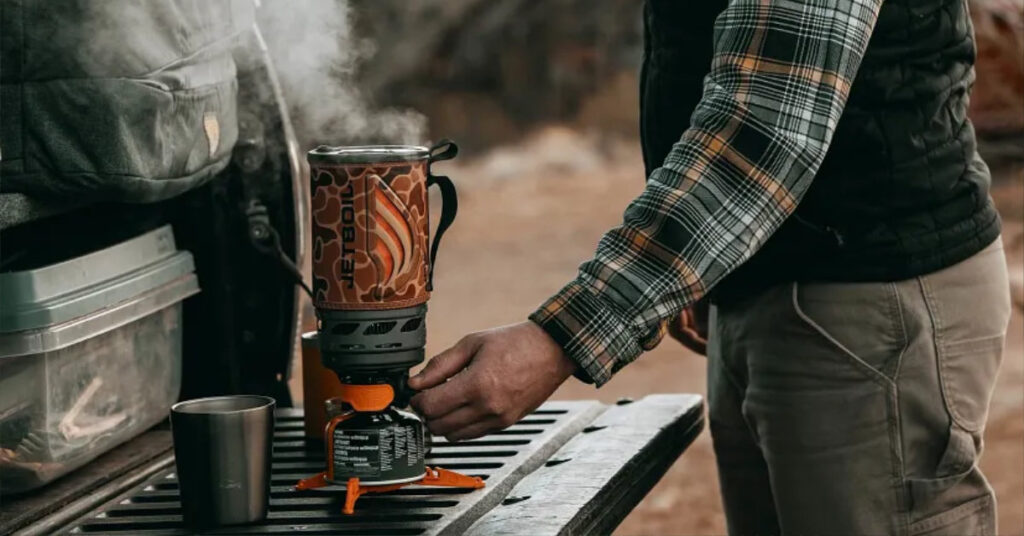 Person using Jetboil stove outdoors
